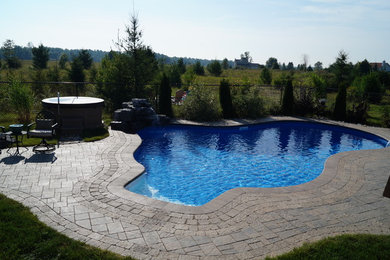 Mid-sized minimalist pool photo in Ottawa
