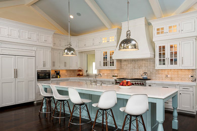 Country l-shaped eat-in kitchen in Chicago with beaded inset cabinets, white cabinets, multi-coloured splashback, dark hardwood floors, with island, marble benchtops, a farmhouse sink, ceramic splashback and panelled appliances.