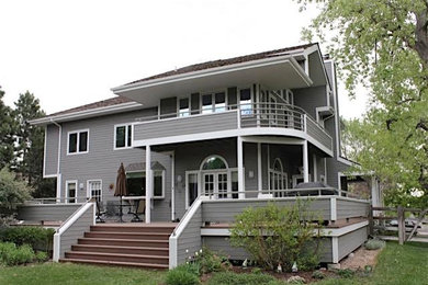 Example of a large classic gray two-story wood exterior home design in Denver with a shingle roof