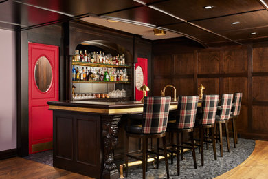 Example of a classic galley marble floor and gray floor seated home bar design in Minneapolis with recessed-panel cabinets, dark wood cabinets and wood countertops