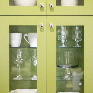 Small midcentury modern kitchen pantry inspiration - Example of a small 1960s galley medium tone wood floor kitchen pantry design in Grand Rapids with an undermount sink, shaker cabinets, green cabinets, laminate countertops, white backsplash, stone tile backsplash, stainless steel appliances and no island