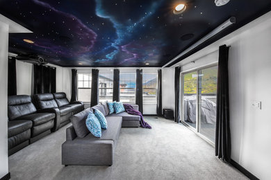 Mid-sized contemporary open concept home theatre in Salt Lake City with white walls, carpet, a projector screen and grey floor.