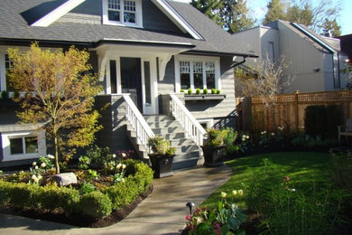 This is an example of a mid-sized traditional drought-tolerant and partial sun front yard concrete paver landscaping in Vancouver.