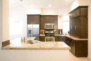 Example of a mid-sized classic l-shaped beige floor eat-in kitchen design in Other with an undermount sink, shaker cabinets, dark wood cabinets, stainless steel appliances and an island
