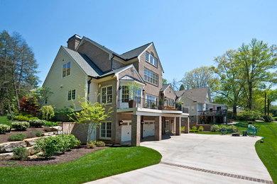 Inspiration for a large timeless three-story brick gable roof remodel in Other