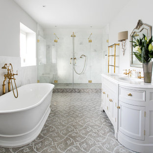Large victorian ensuite bathroom in Surrey with grey cabinets, a freestanding bath, white tiles, stone tiles, grey walls, mosaic tile flooring, marble worktops, recessed-panel cabinets, an alcove shower, a submerged sink and a hinged door.