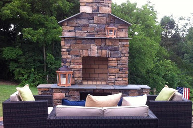 Mid-sized transitional backyard concrete paver patio photo in Baltimore with a fire pit and no cover