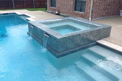 Inspiration for a mid-sized modern backyard rectangular natural pool in Dallas with a hot tub and tile.