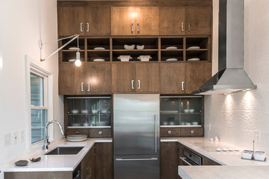 Design ideas for a mid-sized contemporary u-shaped separate kitchen in Minneapolis with an undermount sink, quartz benchtops, white splashback, stainless steel appliances, porcelain floors, grey floor, flat-panel cabinets and dark wood cabinets.