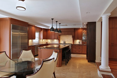 Inspiration for a large transitional u-shaped travertine floor eat-in kitchen remodel in Other with an undermount sink, recessed-panel cabinets, medium tone wood cabinets, quartzite countertops, beige backsplash, stone tile backsplash, stainless steel appliances and an island