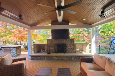 Patio - modern backyard patio idea in Charlotte with a fireplace and a roof extension
