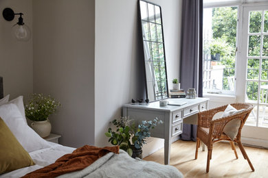 Inspiration for a medium sized contemporary guest bedroom in Buckinghamshire with light hardwood flooring and brown floors.