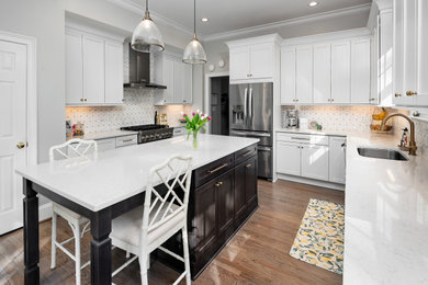 Example of a large transitional u-shaped kitchen design in Charlotte with an undermount sink, recessed-panel cabinets, marble countertops, stainless steel appliances and an island