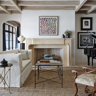 Fernseherloses, Abgetrenntes, Großes Mediterranes Musikzimmer mit weißer Wandfarbe, Kamin, Kalkstein, Kaminsims aus Stein und beigem Boden in Jacksonville