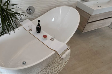 Large scandi ensuite wet room bathroom in Berkshire with flat-panel cabinets, light wood cabinets, a freestanding bath, white tiles, porcelain tiles, white walls, porcelain flooring, a trough sink, beige floors, an open shower, a single sink and a floating vanity unit.