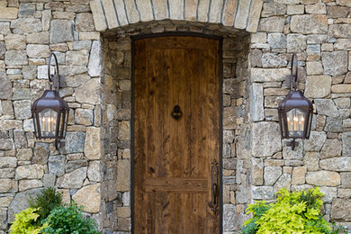 Mountain style gray floor entryway photo in Other with gray walls and a medium wood front door