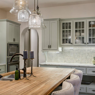 Large traditional eat-in kitchen ideas - Eat-in kitchen - large traditional l-shaped ceramic tile and beige floor eat-in kitchen idea in Dallas with an undermount sink, wood countertops, cement tile backsplash, stainless steel appliances, an island, brown countertops, shaker cabinets, green cabinets and multicolored backsplash