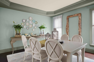 Inspiration for a mid-sized cottage dark wood floor and brown floor enclosed dining room remodel in Vancouver with blue walls and no fireplace