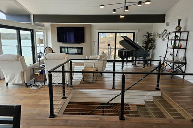 Living room - contemporary open concept medium tone wood floor and shiplap ceiling living room idea in Indianapolis with a music area and a wall-mounted tv