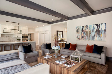 Example of a large trendy open concept dark wood floor and brown floor family room design in Boston with beige walls, a standard fireplace and a wall-mounted tv