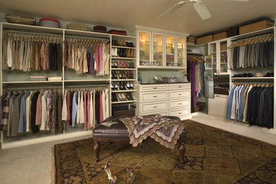 Design ideas for an expansive traditional gender-neutral walk-in wardrobe in Denver with beaded inset cabinets, white cabinets and carpet.