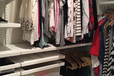 Walk-in closet - mid-sized transitional gender-neutral carpeted and beige floor walk-in closet idea in San Francisco with open cabinets