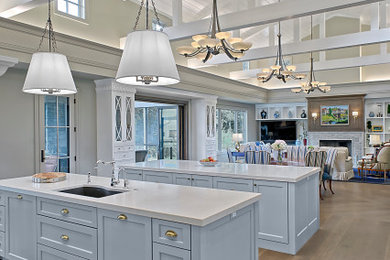 Huge elegant l-shaped medium tone wood floor, brown floor and shiplap ceiling open concept kitchen photo in Grand Rapids with an undermount sink, shaker cabinets, blue cabinets, quartz countertops, blue backsplash, ceramic backsplash, stainless steel appliances, two islands and white countertops