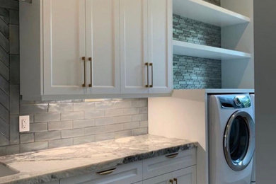 Inspiration for a mid-sized modern galley multicolored floor utility room remodel in Other with a drop-in sink, white cabinets, marble countertops, gray backsplash, gray walls and a side-by-side washer/dryer