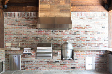 Example of a mountain style backyard tile patio kitchen design in Other