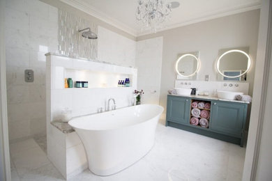 Inspiration for a medium sized contemporary ensuite bathroom in Other with shaker cabinets, green cabinets, a freestanding bath, a walk-in shower, a wall mounted toilet, white tiles, marble tiles, white walls, marble flooring, a built-in sink, marble worktops, white floors, an open shower, white worktops, feature lighting, double sinks and a built in vanity unit.