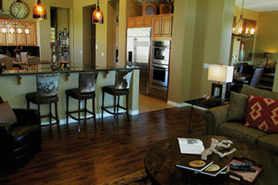 Kitchen - rustic dark wood floor kitchen idea in Phoenix with light wood cabinets, granite countertops, stainless steel appliances and an island