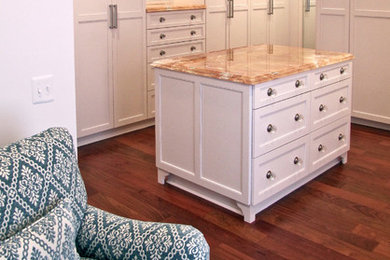 Walk-in closet - large traditional gender-neutral medium tone wood floor and brown floor walk-in closet idea in DC Metro with shaker cabinets and white cabinets