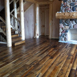 Reclaimed Mixed Hardwood Flooring Near a Log Staircase - Hardwood Flooring