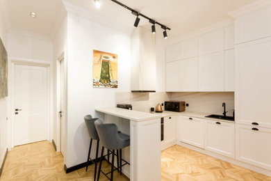 Inspiration for an eclectic light wood floor kitchen remodel in Other with white cabinets, granite countertops, white backsplash, porcelain backsplash, colored appliances and white countertops