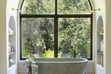 Huge tuscan master beige tile and cement tile marble floor, beige floor, double-sink and vaulted ceiling bathroom photo in Santa Barbara with recessed-panel cabinets, brown cabinets, a one-piece toilet, white walls, an undermount sink, quartz countertops, a hinged shower door, white countertops and a built-in vanity