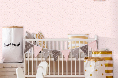 This is an example of a modern nursery in Wilmington with pink walls.