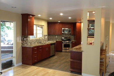 Inspiration for a large transitional l-shaped dark wood floor enclosed kitchen remodel in Santa Barbara with a double-bowl sink, flat-panel cabinets, dark wood cabinets, granite countertops, multicolored backsplash, matchstick tile backsplash, stainless steel appliances and an island