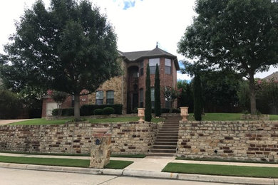 Large traditional red two-story brick house exterior idea in Dallas with a hip roof and a shingle roof