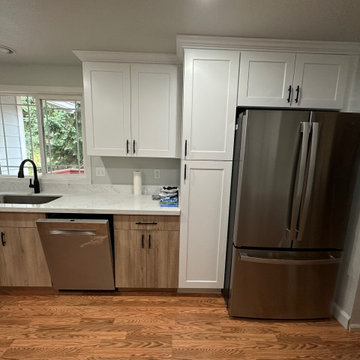 3-doors refrigerator next to pantry cabinets for all the goods in one area