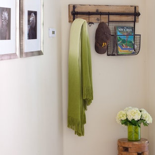 Inspiration for a small country entryway in Phoenix with beige walls and ceramic floors.