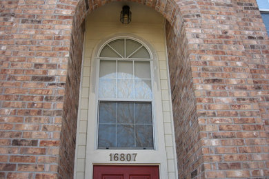 Mid-sized two-story brick exterior home photo in Austin