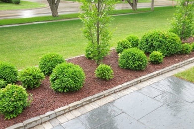 Contemporary formal garden in Cedar Rapids with natural stone pavers.