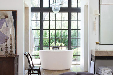 Inspiration for a large timeless master concrete floor freestanding bathtub remodel in San Francisco with open cabinets, black cabinets, white walls and marble countertops