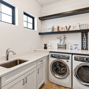 シンシナティのカントリー風おしゃれな洗濯室 (アンダーカウンターシンク、白いキャビネット、クオーツストーンカウンター、白い壁、トラバーチンの床、左右配置の洗濯機・乾燥機、白いキッチンカウンター、落し込みパネル扉のキャビネット、ベージュの床) の写真