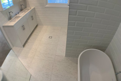 Design ideas for a mid-sized contemporary 3/4 bathroom in Brisbane with shaker cabinets, white cabinets, white tile, ceramic tile, engineered quartz benchtops, white benchtops, a double vanity and a built-in vanity.