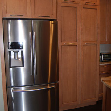 MEDIUM STAIN CABINETRY WITH ROMA IMPERIALE QUARTZITE