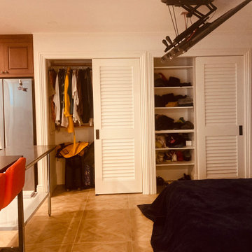with doors opened (notice TV installed on ceiling above bed)