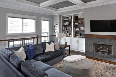 Large transitional open concept dark wood floor and brown floor family room photo in Chicago with gray walls, a standard fireplace, a tile fireplace and a wall-mounted tv
