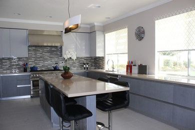 Inspiration for a contemporary u-shaped eat-in kitchen remodel in Los Angeles with flat-panel cabinets, gray cabinets, multicolored backsplash, matchstick tile backsplash and an island