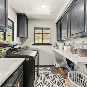 Functional Laundry Room with Black Cabinetry and Patterned Flooring